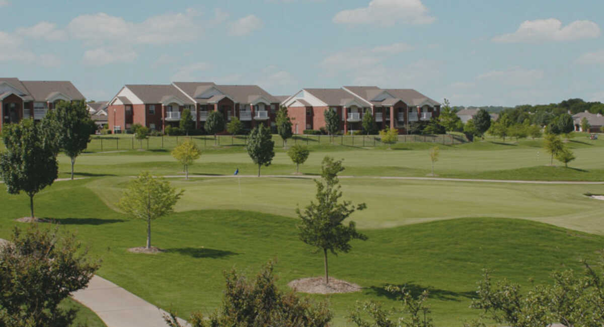 Course view with apartments in background